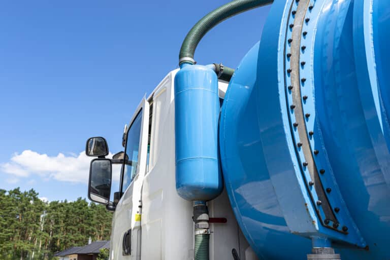 A truck with a large tank for pumping out a septic tank with a capacity of more than 20 cubic meters, visible fill indicator and overflow valve